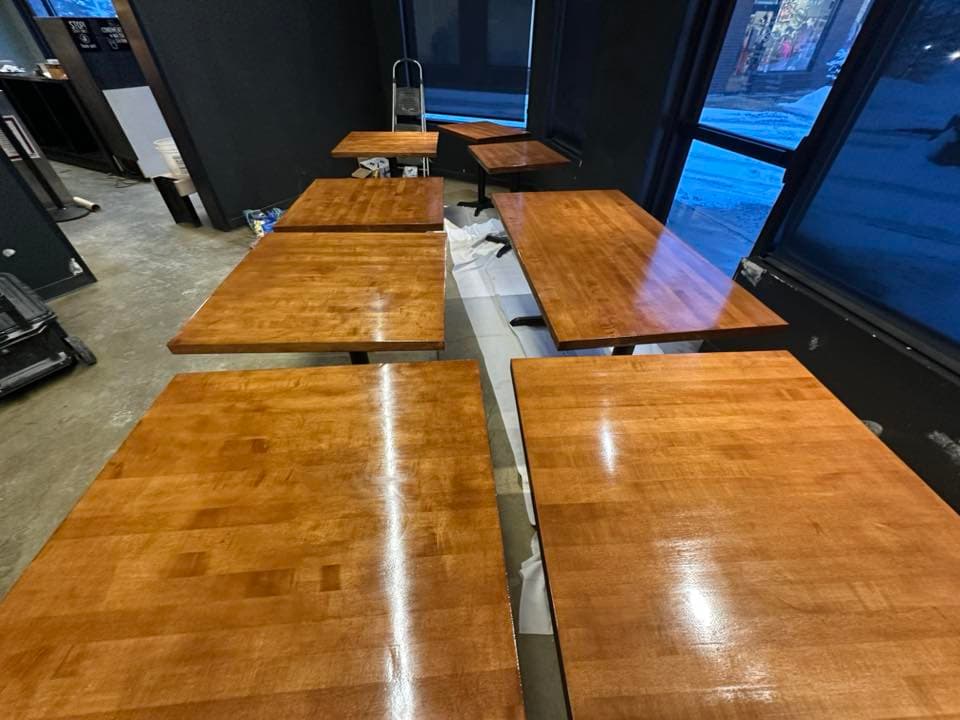 Restaurant tables after staining — rich glossy wood finish