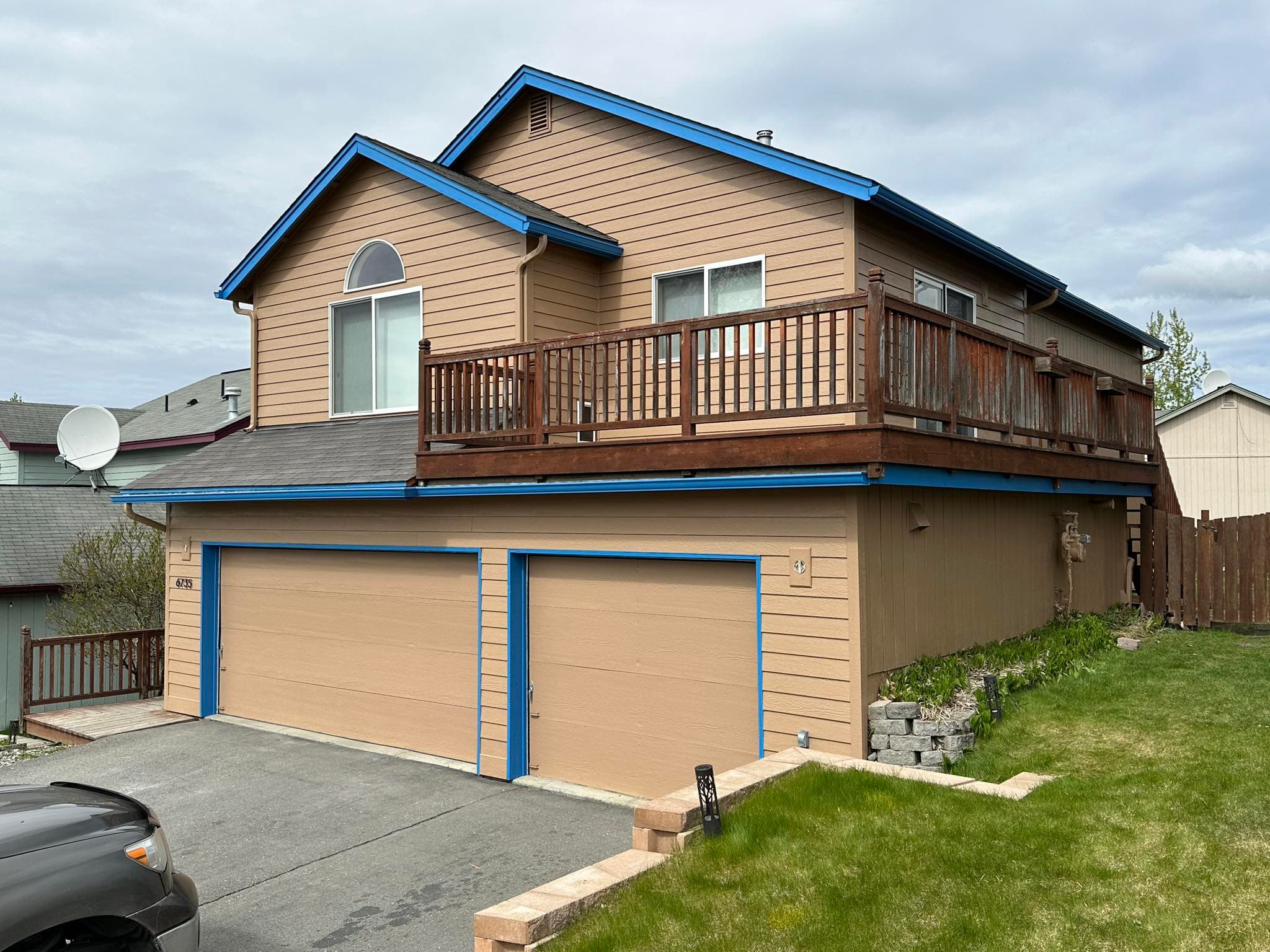Two-story home with fresh exterior painting and blue trim in Anchorage