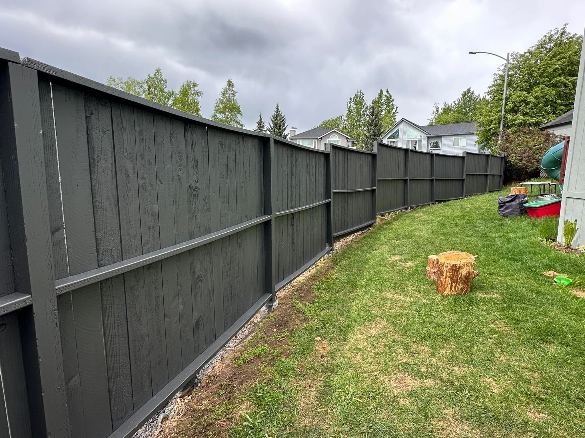 Fence after painting — clean dark gray professional finish