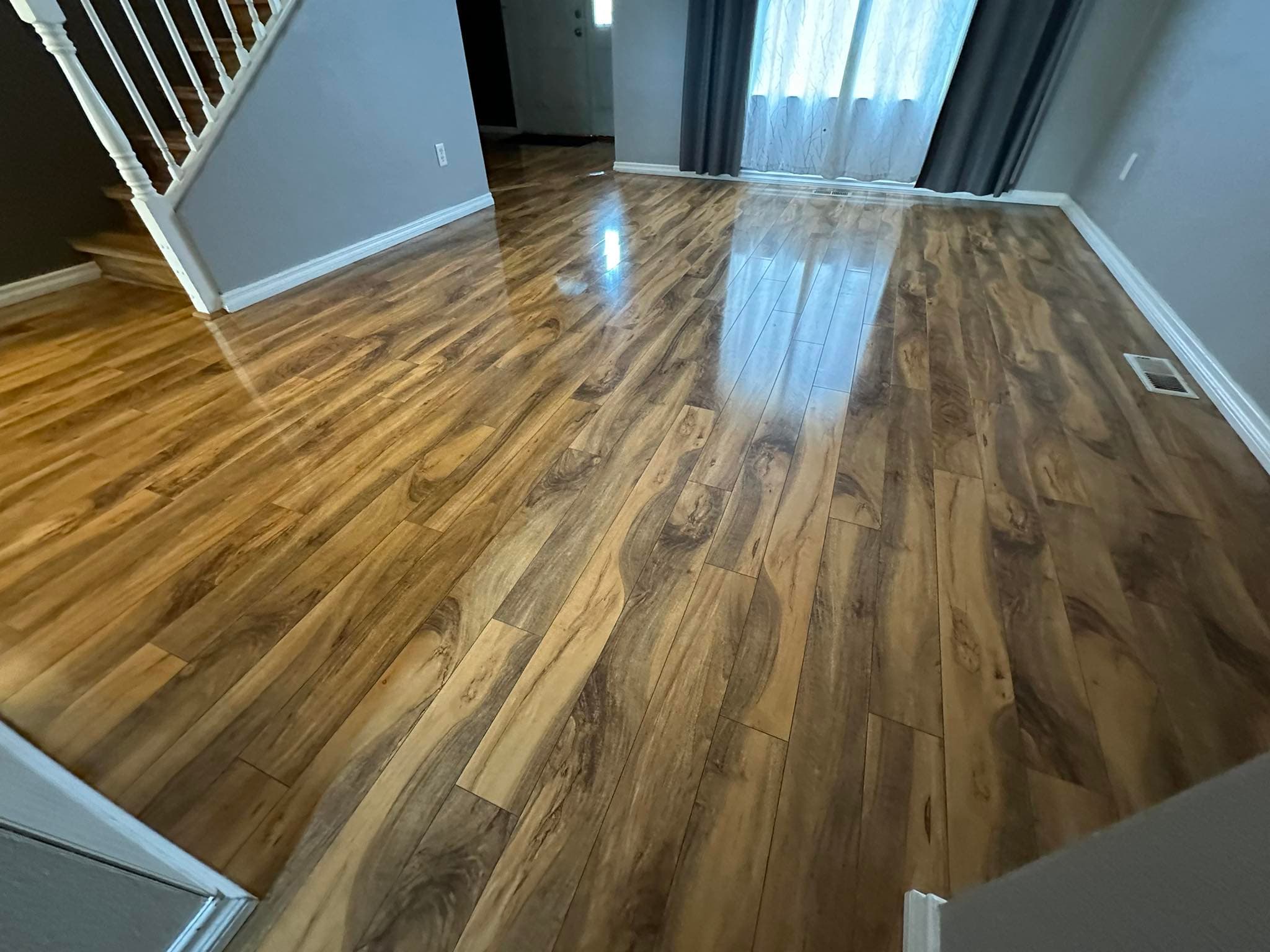 Hardwood flooring installation in living room with warm natural finish